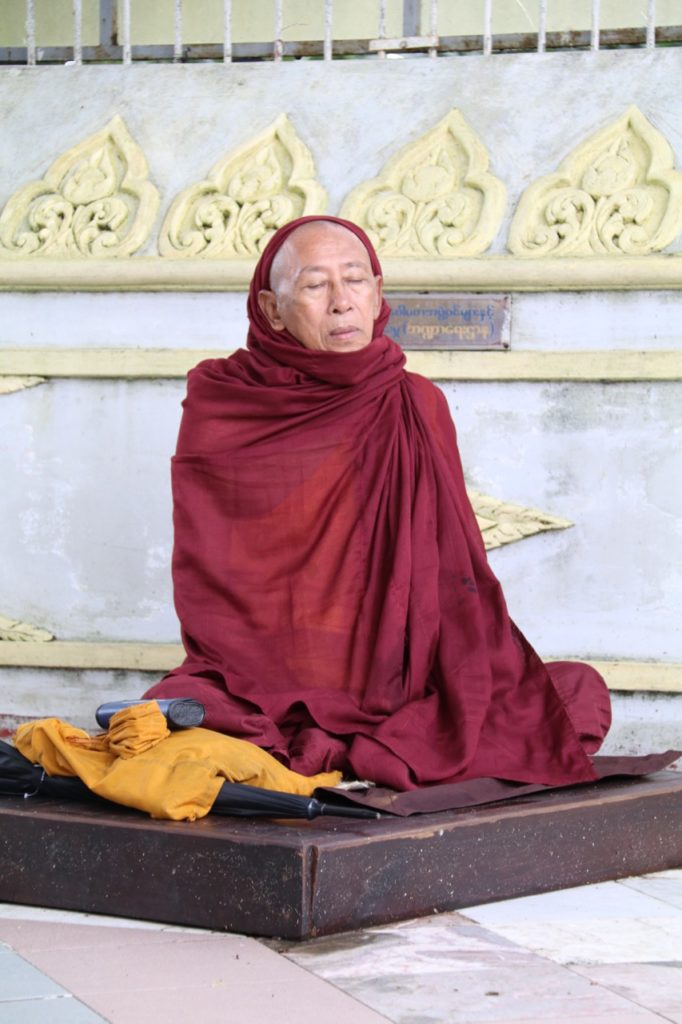 A MEDITATING MONK AT THE SHWEDAGON PAGODA