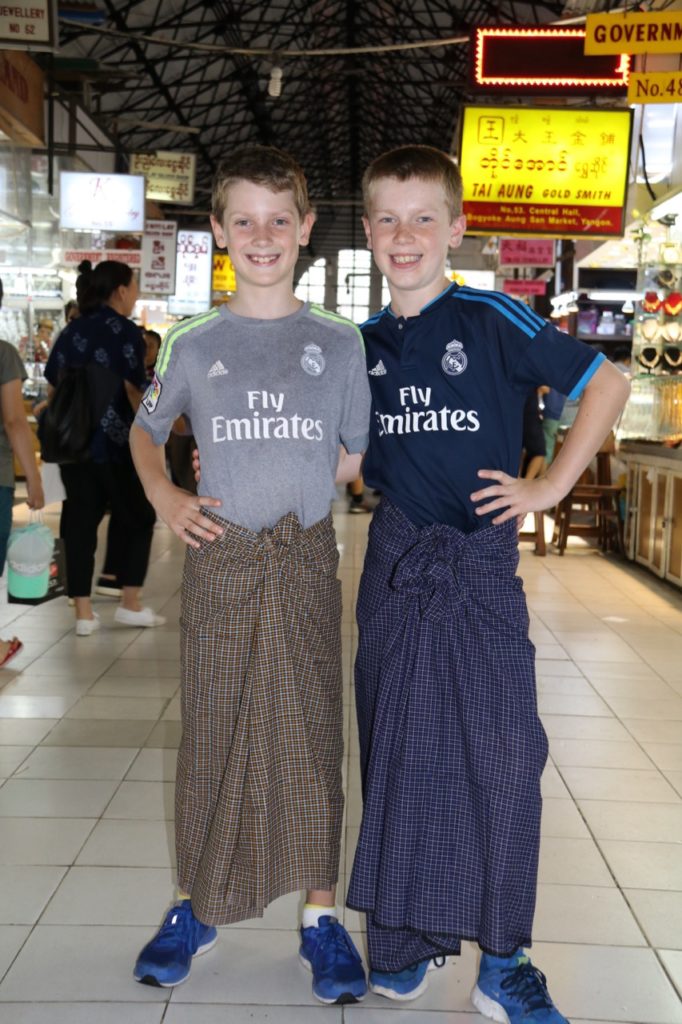 FLYNN AND LOGAN WEARING TRADITIONAL LONGYI...