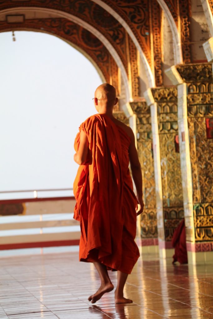A MONK IN A BUDDHIST TEMPLE ON MANDALAY HILL