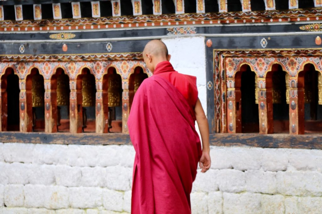 A red-robbed monk at Thimphu Dzong in Bhutan