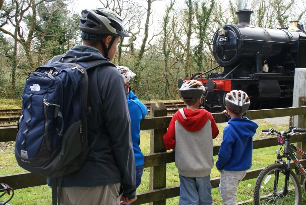 Stopping to watch the steam train on the Bodmin and Wenford Railway while cycling the Camel Trail