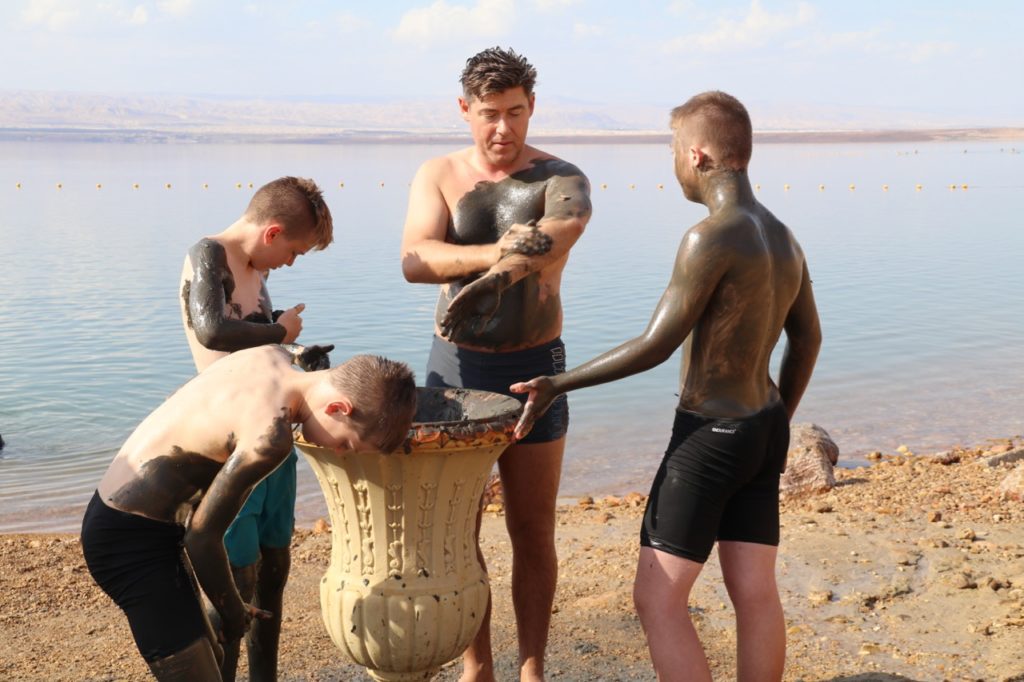 Applying mud at the Dead Sea