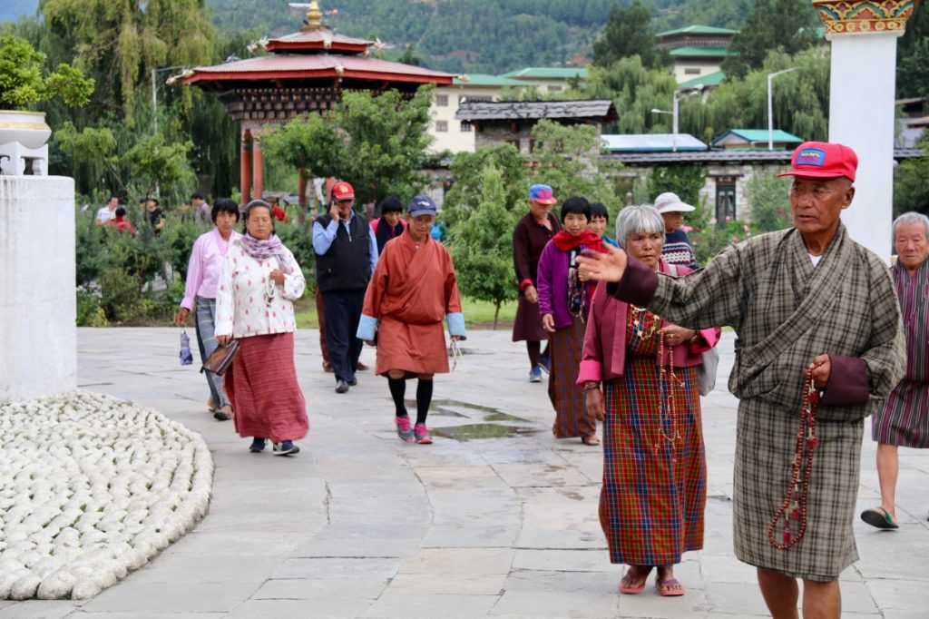 Walking around the National Chorten in Thimphu twirling prayer beads